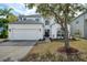 Charming two-story home boasts an attached two-car garage and a well-manicured front yard at 14217 Sapphire Bay Cir, Orlando, FL 32828