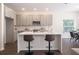 Modern kitchen with sleek gray cabinets, a white quartz countertop island, and stainless steel appliances at 14217 Sapphire Bay Cir, Orlando, FL 32828