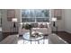 Inviting living room featuring a plush sofa, stylish decor, and a large window with serene views at 14217 Sapphire Bay Cir, Orlando, FL 32828