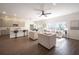 Bright, open-concept living room connects to a modern kitchen, perfect for entertaining and relaxation at 14217 Sapphire Bay Cir, Orlando, FL 32828