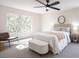 Spacious main bedroom filled with natural light, featuring a ceiling fan and neutral décor at 14217 Sapphire Bay Cir, Orlando, FL 32828