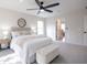 Bright main bedroom features a ceiling fan, neutral decor, and convenient access to the ensuite bathroom at 14217 Sapphire Bay Cir, Orlando, FL 32828