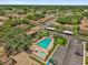 Aerial view of community pool, parking, and well-maintained landscaping at 200 St Andrews Blvd # 802, Winter Park, FL 32792