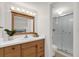 Well-lit bathroom featuring a glass-enclosed shower and a wood vanity at 200 St Andrews Blvd # 802, Winter Park, FL 32792