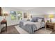 Serene bedroom boasts natural light, a plush bed, and calming neutral tones at 200 St Andrews Blvd # 802, Winter Park, FL 32792