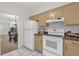 Functional kitchen showcasing a refrigerator, stove, tile floors, and seamless access to the dining area at 200 St Andrews Blvd # 802, Winter Park, FL 32792
