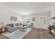 Comfortable living room with a large window, plush seating, and warm, inviting light at 200 St Andrews Blvd # 802, Winter Park, FL 32792