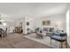 Bright living room features neutral decor, a modern coffee table, and access to the dining area at 200 St Andrews Blvd # 802, Winter Park, FL 32792