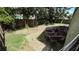 Backyard with stone fire pit, partially bricked patio, and fenced perimeter offering privacy and space at 324 River Chase Dr, Orlando, FL 32807