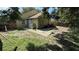Large backyard featuring a partially bricked patio area, providing potential for landscaping and outdoor enjoyment at 324 River Chase Dr, Orlando, FL 32807