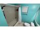 Bright bathroom featuring a tiled shower and turquoise walls at 324 River Chase Dr, Orlando, FL 32807