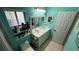 Bright bathroom featuring a dual sink vanity with tiled floor and turquoise walls at 324 River Chase Dr, Orlando, FL 32807