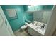 Modern bathroom with dual vanity and turquoise walls at 324 River Chase Dr, Orlando, FL 32807