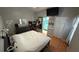 Well-lit bedroom featuring a large bed, dresser, and direct access to a full bathroom at 324 River Chase Dr, Orlando, FL 32807