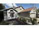 View of front of house featuring garden area, and a light-blue front door at 324 River Chase Dr, Orlando, FL 32807