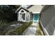 View of front of house featuring garden area, and a light-blue front door at 324 River Chase Dr, Orlando, FL 32807