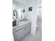 Bright bathroom featuring gray cabinets and marble-style floors at 4152 Pino St, Apopka, FL 32712