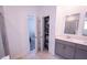 Spacious bathroom with a double vanity, glass shower, and open shelving, perfect for storage at 4152 Pino St, Apopka, FL 32712