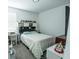 Comfortable bedroom with carpet, a cozy bed, and a well-lit desk area with an overhead shelf at 4152 Pino St, Apopka, FL 32712