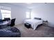 Cozy bedroom featuring soft carpet, a comfortable bed, and a desk for a functional workspace at 4152 Pino St, Apopka, FL 32712