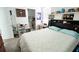 Bright bedroom featuring carpet floors, white walls, and decor shelves above the headboard at 4152 Pino St, Apopka, FL 32712