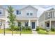Charming two-story home with stylish blue door, well-maintained lawn, and inviting front porch at 4152 Pino St, Apopka, FL 32712