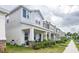 Charming two-story townhomes with attractive architectural details and inviting front porches on a sunny day at 4152 Pino St, Apopka, FL 32712