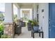 Inviting front porch featuring stylish seating, stone columns, and view of a landscaped street at 4152 Pino St, Apopka, FL 32712