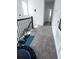 Upstairs hallway featuring carpet flooring, natural light, and wrought iron railing at 4152 Pino St, Apopka, FL 32712