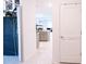 Bright hallway with tile flooring leading to a modern kitchen with gray cabinets at 4152 Pino St, Apopka, FL 32712