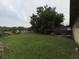 Large backyard with mature trees and a screened in porch area at 728 Springview Dr, Orlando, FL 32803