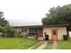 Single story home with lawn, trees, and a two-car driveway leading to the side of the property at 728 Springview Dr, Orlando, FL 32803
