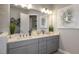 Bathroom boasts double sinks, granite counters, and modern lighting at 858 Arbor Green Trl, St Cloud, FL 34771