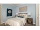 Bedroom with soft blue walls, stylish decor, and a comfortable-looking bed at 858 Arbor Green Trl, St Cloud, FL 34771
