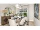 Charming dining room boasts stylish decor, modern lighting, and a window with a neighborhood view at 858 Arbor Green Trl, St Cloud, FL 34771