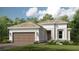 Beautiful single-story home with a well-manicured lawn and a two-car garage at 858 Arbor Green Trl, St Cloud, FL 34771