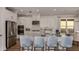 Open kitchen with a large island, stainless steel appliances, and stylish blue bar stools at 858 Arbor Green Trl, St Cloud, FL 34771