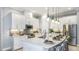 Bright kitchen with white cabinetry, marble countertops, and modern stainless steel appliances at 858 Arbor Green Trl, St Cloud, FL 34771