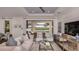 Bright living room featuring elegant furniture, stylish decor, and access to an outdoor patio with water views at 858 Arbor Green Trl, St Cloud, FL 34771
