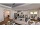 Open-concept living space featuring a kitchen, dining area, and living room with stylish furnishings at 858 Arbor Green Trl, St Cloud, FL 34771