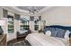 Luxurious main bedroom with large windows, a cozy sitting area, and elegant decor at 858 Arbor Green Trl, St Cloud, FL 34771