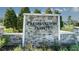 Stone monument sign for Preservation Pointe community, surrounded by manicured landscaping at 1341 Sawgrass Hammock Ln, Davenport, FL 33837