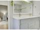 Bathroom featuring double sink vanity with white countertop, framed mirror, and decorative vines at 643 Oregon Woods Ct, Orlando, FL 32824