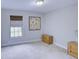 Bedroom with neutral walls, carpeted floor, window, and a bedside table with lamp at 643 Oregon Woods Ct, Orlando, FL 32824