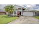 Well-maintained home with a spacious driveway, two-car garage, and beautifully landscaped front yard at 643 Oregon Woods Ct, Orlando, FL 32824