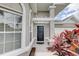 Inviting front entrance with a classic black door, white trim, and colorful landscaping at 643 Oregon Woods Ct, Orlando, FL 32824