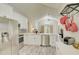 Bright kitchen featuring stainless steel appliances, white cabinetry, and an open layout to the living area at 643 Oregon Woods Ct, Orlando, FL 32824
