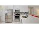 Updated kitchen featuring stainless steel appliances, white cabinets, and a mosaic backsplash at 643 Oregon Woods Ct, Orlando, FL 32824
