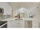 Modern kitchen with white cabinets, stainless steel appliances, and a view into the living room at 643 Oregon Woods Ct, Orlando, FL 32824