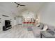 Open-concept living room and kitchen area with vaulted ceilings and modern decor at 643 Oregon Woods Ct, Orlando, FL 32824